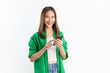 © sitthiphong - Beautiful Asian woman holding smartphone and smiling on white background.