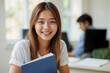 © polack - Portrait of happy smiling Asian student girl in classroom looking at camera
