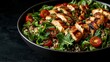 © Muhammad - Grilled chicken and quinoa salad in a bowl.