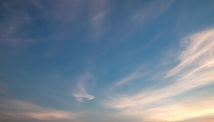 Wall Mural - the sky is clear with fiuffy white clouds and beautiful orange light.