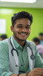 © Niks Ads - indian male doctor sitting on desk and smiling