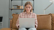 © stockbakers - Young Woman Working on Laptop while Sitting Outdoor on Bench
