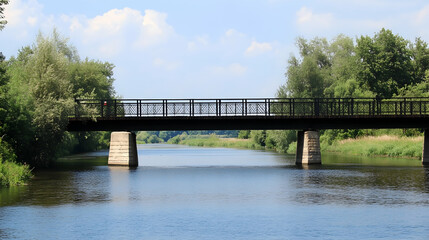 Wall Mural - Scenic view of a metal bridge over a tranquil river, surrounded by lush trees under a partly cloudy sky, ideal for travel brochures