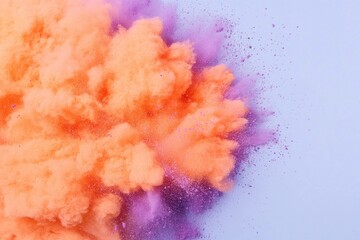 Canvas Print - A vibrant orange and purple powder explosion against a soft blue background, symbolizing joy and creativity in a colorful abstract concept