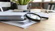 © 洁 张 - Close-up of a neatly organized stack of insurance documents with a magnifying glass on top, showcasing professionalism and attention to detail in a modern office setting.