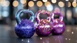 © Yuliia - Glittering kettlebells in blue, pink and purple colors with sparkly coating against blurred bokeh background. Fitness equipment with decorative festive appearance.