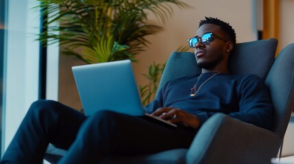 Side view photo of relaxing young funny guy lying comfortable armchair in office while reviewing his website code app indoors workplace