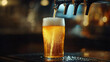 © Farid - A refreshing light draft beer being poured from a pub tap into a glass