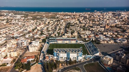 Wall Mural - Aerial view of coastal city with stadium and sea in Larnaca, Cyprus