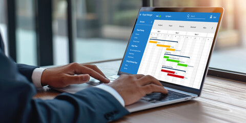 Project planning software for brisk business project management on the computer screen showing timeline chart of the team project