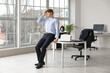 © Pixel-Shot - Tired young businessman suffering from headache in office
