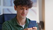© stockbusters - Freelancer chatting social networks using cellphone at home workplace closeup.
