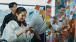 © Summit Art Creations - Portrait of professional business team brainstorming marketing idea by using sticky notes to share creative idea at glass wall. Group of diverse business team discuss about strategy. Manipulator.