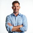 © miss irine - Confident mature businessman wearing blue shirt posing on white background. Happy successful grey haired executive smiles with arms crossed. Middle aged man in 50s looks smart, cheerful, attractive.