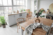 © Pixel-Shot - Interior of light kitchen with dining table, counters and shelf unit