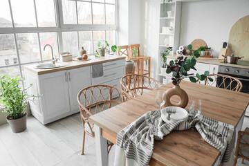 Wall Mural - Interior of light kitchen with dining table, counters and shelf unit