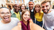 © Davide Angelini - Multicultural young people smiling together at camera outside - Happy friends taking selfie pic with smart mobile phone device - College students having fun - Youth community concept
