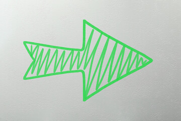 Wall Mural - one green arrow on light grey textured background. pointer
