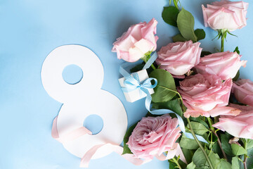 Wall Mural - Rose flowers on blue spring background, 8 march day festive background, flowers for international womans day 8 of march