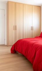 Wall Mural - Modern bedroom with red bedding and light wood cabinets. Interior design