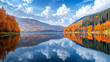 © mahamad - A serene lake in the mountains reflects stunning autumn scenery, featuring vibrant forests and a beautiful cloudscape.