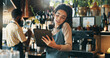 © peopleimages.com - Phone call, tablet and planning with woman in restaurant for product inventory, supplier contact or budget discussion. Menu discount, bar service and small business owner with employee in coffee shop