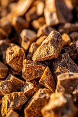 Wall Mural - Close-up of brown stones under warm light; background blurred. Landscaping use