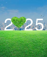 Wall Mural - Tree in the shape of heart love with 2025 white text on green grass field over modern city tower and skyscraper, Happy New Year and Valentines day 2025 cover concept