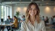 © Janis - Confident smiling woman in modern office, business success concept