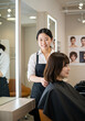 © rfassets - Hairstylist Cuts Client's Hair in a Modern Hair Salon