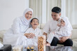 © Creativa Images - Happy Muslim Family Spending Quality Time Together at Home