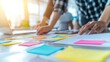 © lemoncraft - Close-up of diverse group of people collaborating and brainstorming ideas at a modern office. Sticky notes used for project planning. Teamwork, business planning, and creative ideas are in process..