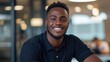 © Lifestyle Images - Close-up portrait of a young african-american man with a big smile on his face. he is wearing a black polo shirt and has short, dark hair and a beard.