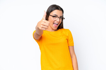 Wall Mural - Young caucasian woman isolated on white background with thumbs up because something good has happened