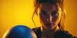 © Oleg - Woman holding soccer ball with serious expression, looking into the distance. Indoor studio setting with dramatic lighting.