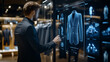 © Topuria Design - Stylish businessman using interactive touchscreen choosing digital clothes in futuristic clothing store