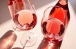 © Alena - Rose wine assortment in crystal glasses, bottle of rose champagne sparkling wine with daylight and shadows. Summer alcoholic drink top view, winetasting concept.