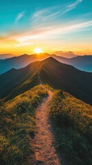 Wall Mural - Sunrise over rugged mountain peaks and winding trail