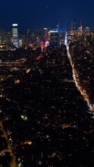 Wall Mural - Light lines of highways in the night cityscape of New York. Luminous city from aerial perspective. Vertical video