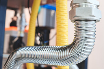 Canvas Print - A close up of a group of metal pipes as industrial background. pipes are silver and have a shiny appearance. Concept of industrial Chemical pharmaceutical device