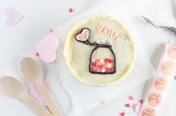 A small Korean bento cake for one or two person with romantic decor on light background.