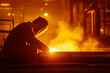 © Frank Parker - Welder works on metal in a bright workshop with intense sparks and orange glow during evening hours