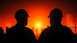 © Kingdola - Silhouettes of Construction Workers: Two construction workers stand silhouetted against a fiery sunset, their hard hats casting long shadows as they contemplate a sprawling cityscape.