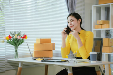 Portrait of Starting small businesses SME owners female entrepreneurs working on receipt box and check online orders to prepare to pack the boxes, sell