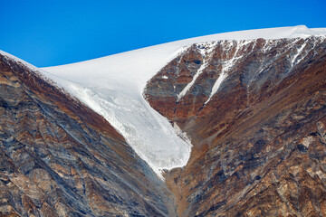 Wall Mural - a hanging glacier in dickson fjord, northeast greenland, arctic. colorful mountain with clear blue s