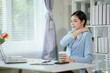© Witoon - An Asian businesswoman sits at her desk, exhausted from working for a long time.