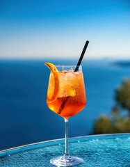 A vibrant cocktail sits on a glass table next to an infinity pool, shimmering under the sunlight against a breathtaking ocean view. The refreshment captures the essence of relaxation and pleasure