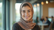 © lina - portrait of a smiling young woman in a hijab and business attire