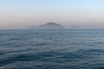 Wall Mural - sea and island with fog at dawn