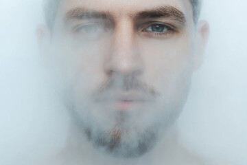 Wall Mural - A man's face is obscured by a foggy mist, creating a sense of mystery